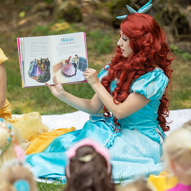 Reading books is one of The Little Mermaid’s favorite pastimes. She’ll read your little one a book with the help of The Princess Party Co.